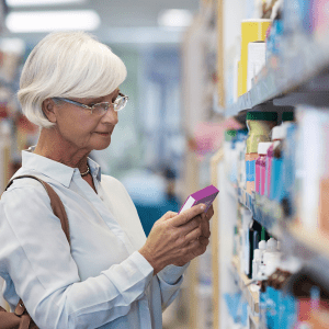 woman reading label on folding carton